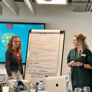 Two researchers, presenting from a flip chart