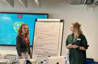 Two researchers, presenting from a flip chart